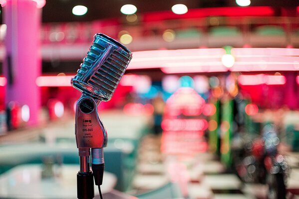 Art photo of a microphone on a stand on the background of a stage