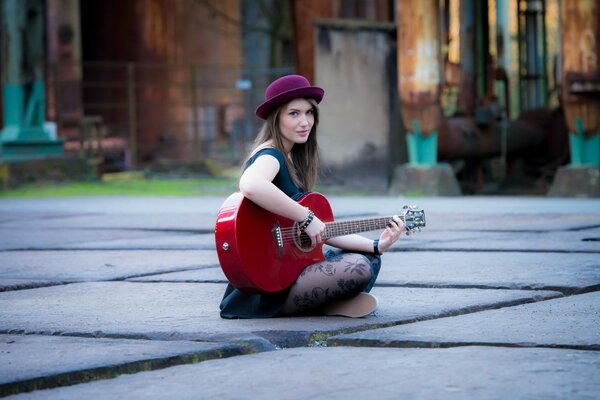 A girl in a hat on the city asphalt