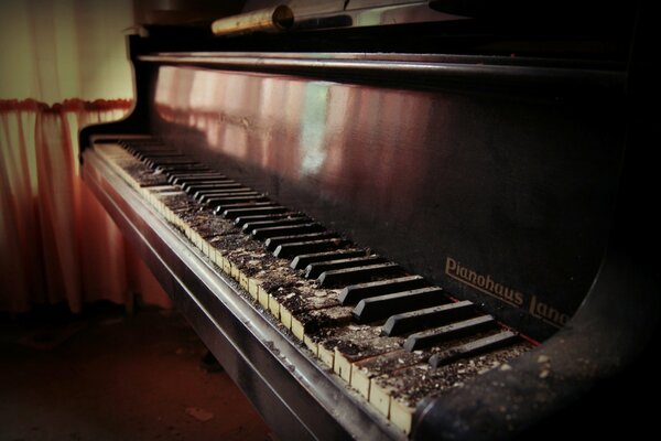 An old abandoned house with a grand piano and a piano in it