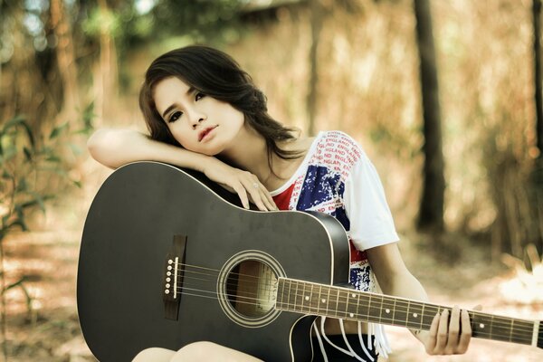 Thoughtful brunette with a guitar