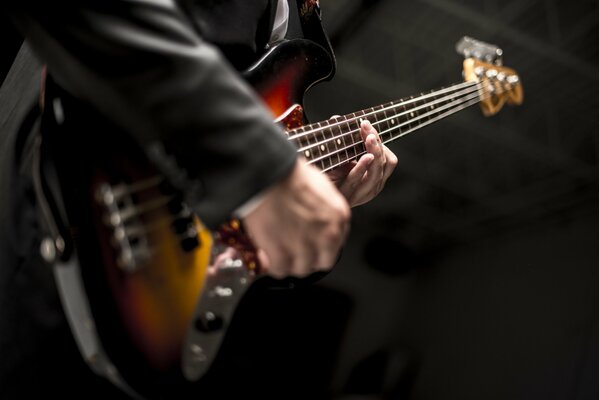 A musician with a guitar on a black background