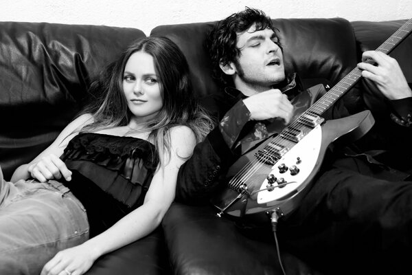 Vanessa and Mathieu with guitar on the couch