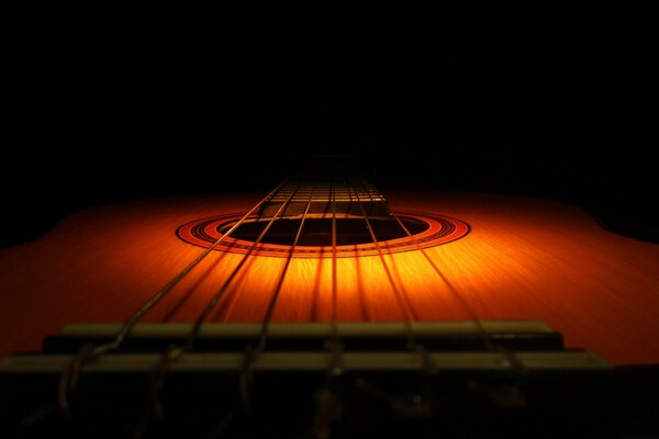 Guitarra acústica bajo luz