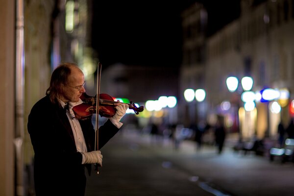 Violinista en la calle por la noche