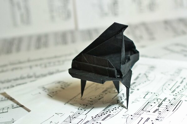 A piano made of paper. Origami. Notes