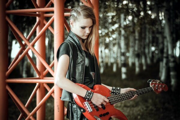 A rocker girl plays a red guitar