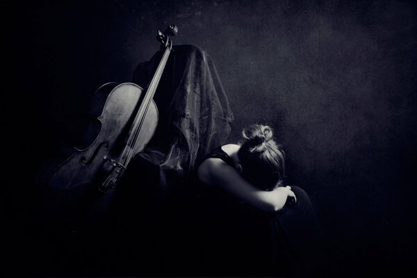 The girl at the cello in dark colors