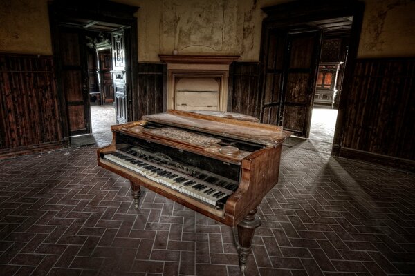 An old piano in the middle of an abandoned house