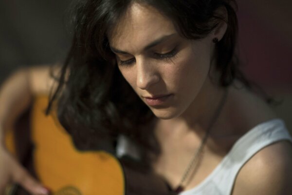 Portrait of a girl playing the guitar