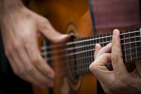 Hands playing the guitar