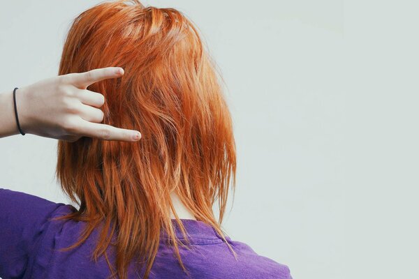 Red-haired girl with a hand gesture