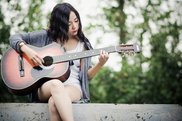 Belle fille jouant de la musique à la guitare