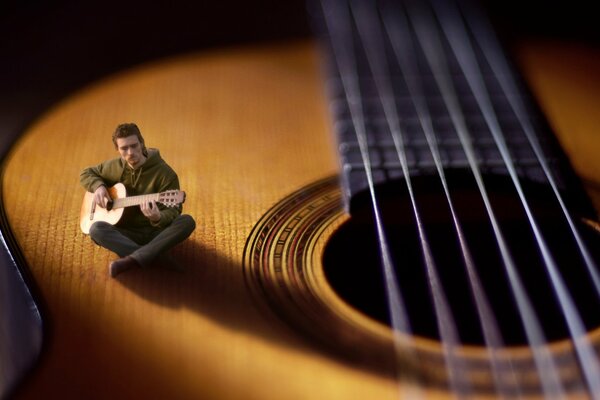 Macro effect of a violin and a man is sitting on it