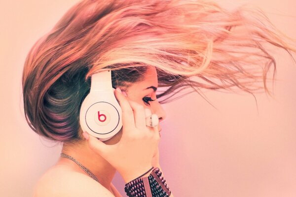 A girl in headphones with beautiful hair