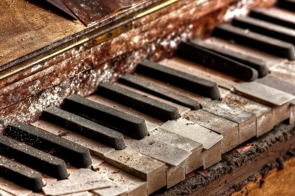 Antique piano in the dust