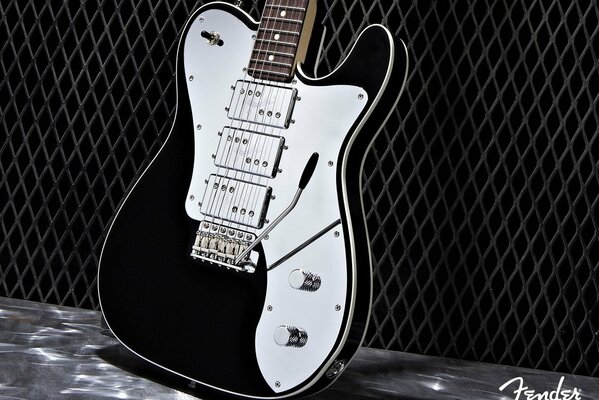 Guitare électrique noir et blanc sur fond noir