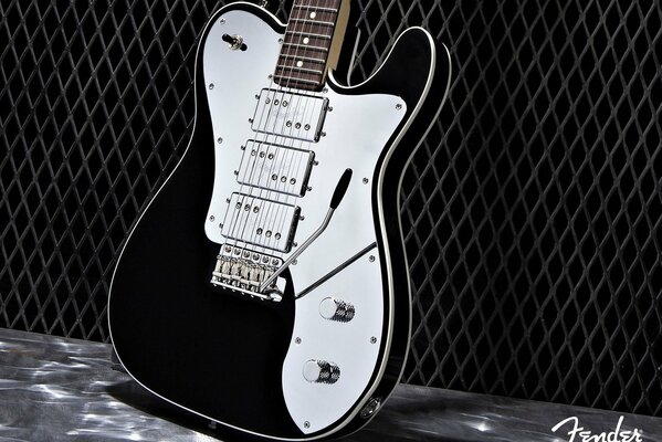 Gitara elektryczna czarno-biała na czarnym tle