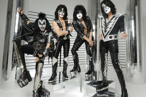 Four rockers in costumes and makeup