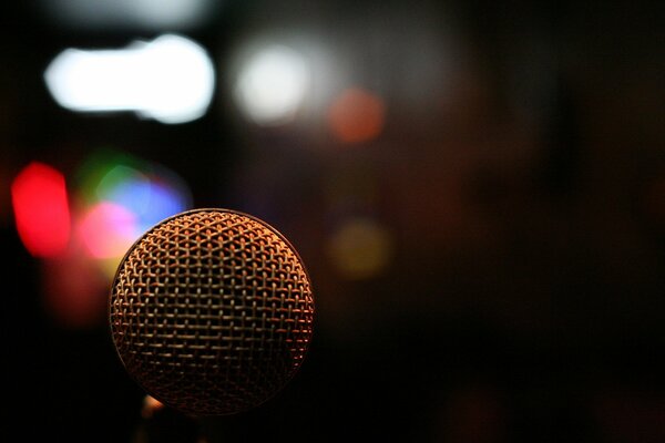 Macro shooting microphone on a dark background with bright lights