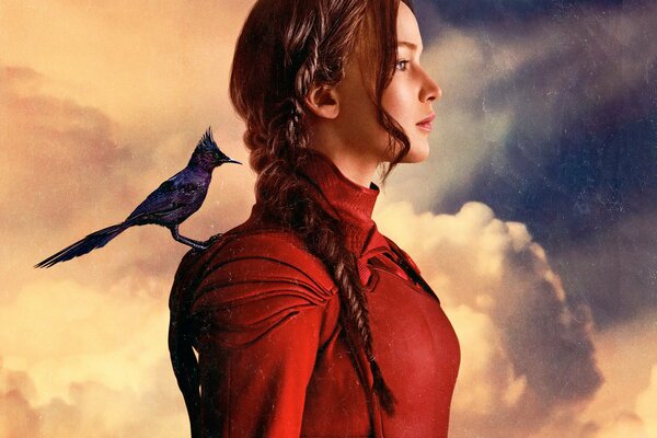 The girl from The Hunger Games stands in profile against the sky