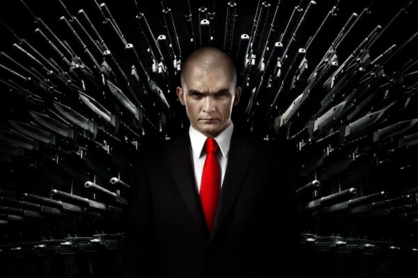 Hitman: Agent 47, Rupert Friend in a black suit and red tie