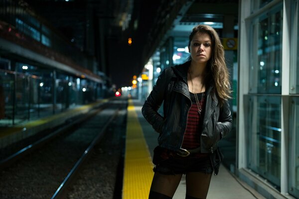 A girl in the dark at the station alone