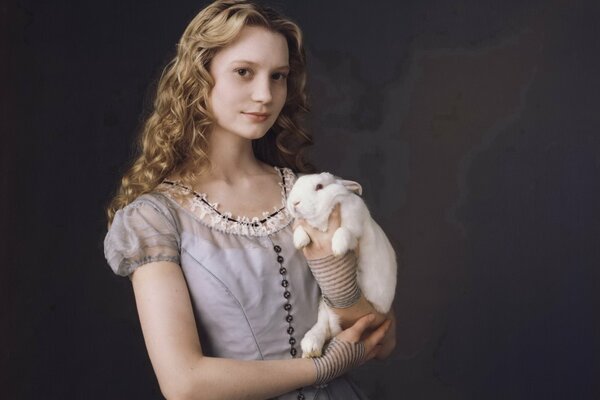 Alice in a dress with a rabbit