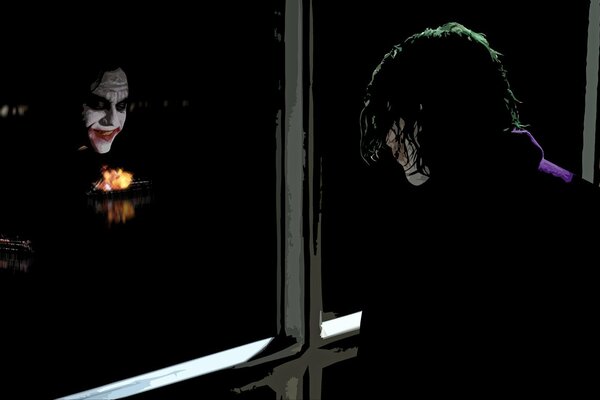 The Joker s face is frighteningly reflected in the glass