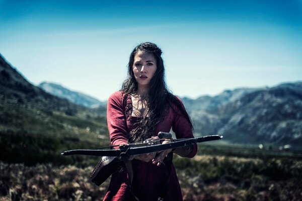 A girl with a bow, around the mountain and a clear day