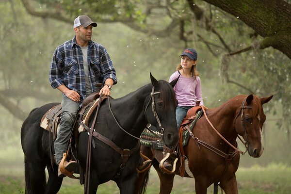 People in caps on horseback on a walk