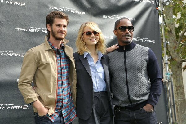 Actors from Spider-Man two pose on a black background