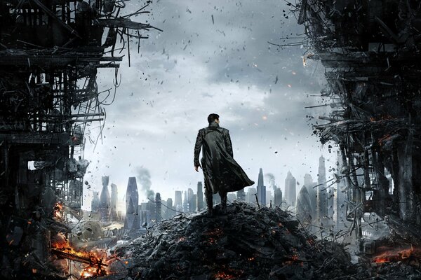 Retribution. A man in a raincoat in front of the wreckage of the city