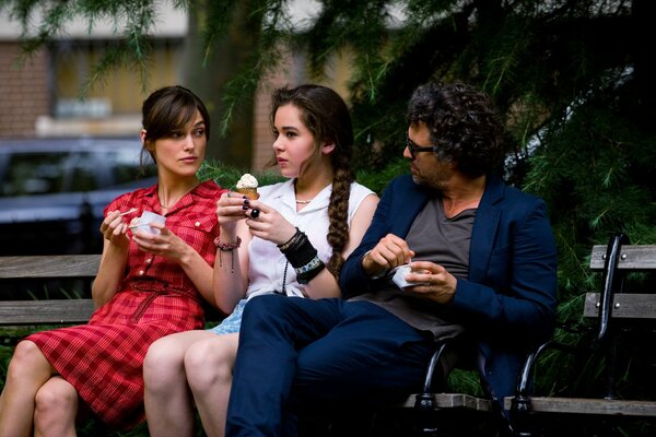 Actors sitting on a bench with ice cream