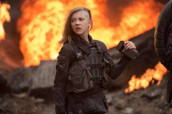 Cressida from the Hunger Games on the background of fire