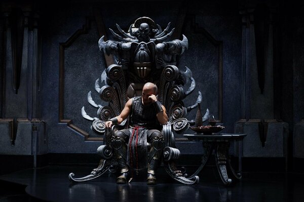 A man in armor sits on a throne