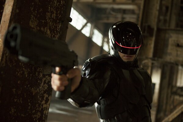 Robocop the man of the future in black with a gun