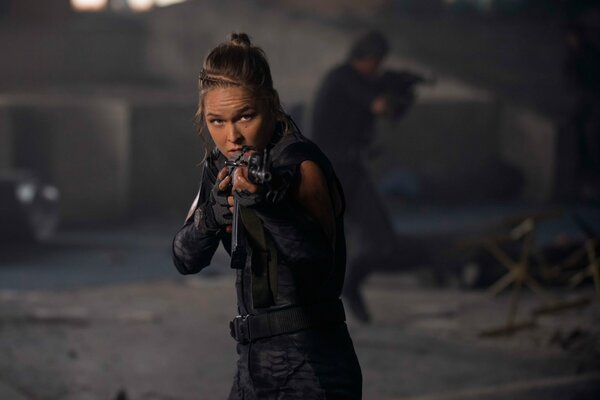 The movie The Expendables . A girl with a gun.