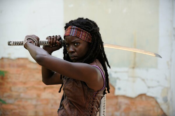 Michonne with a raised sword over her head