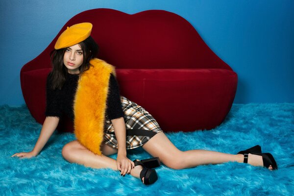 A girl in a yellow beret on a beautiful background of lips