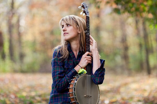 A woman with a musical instrument banjo