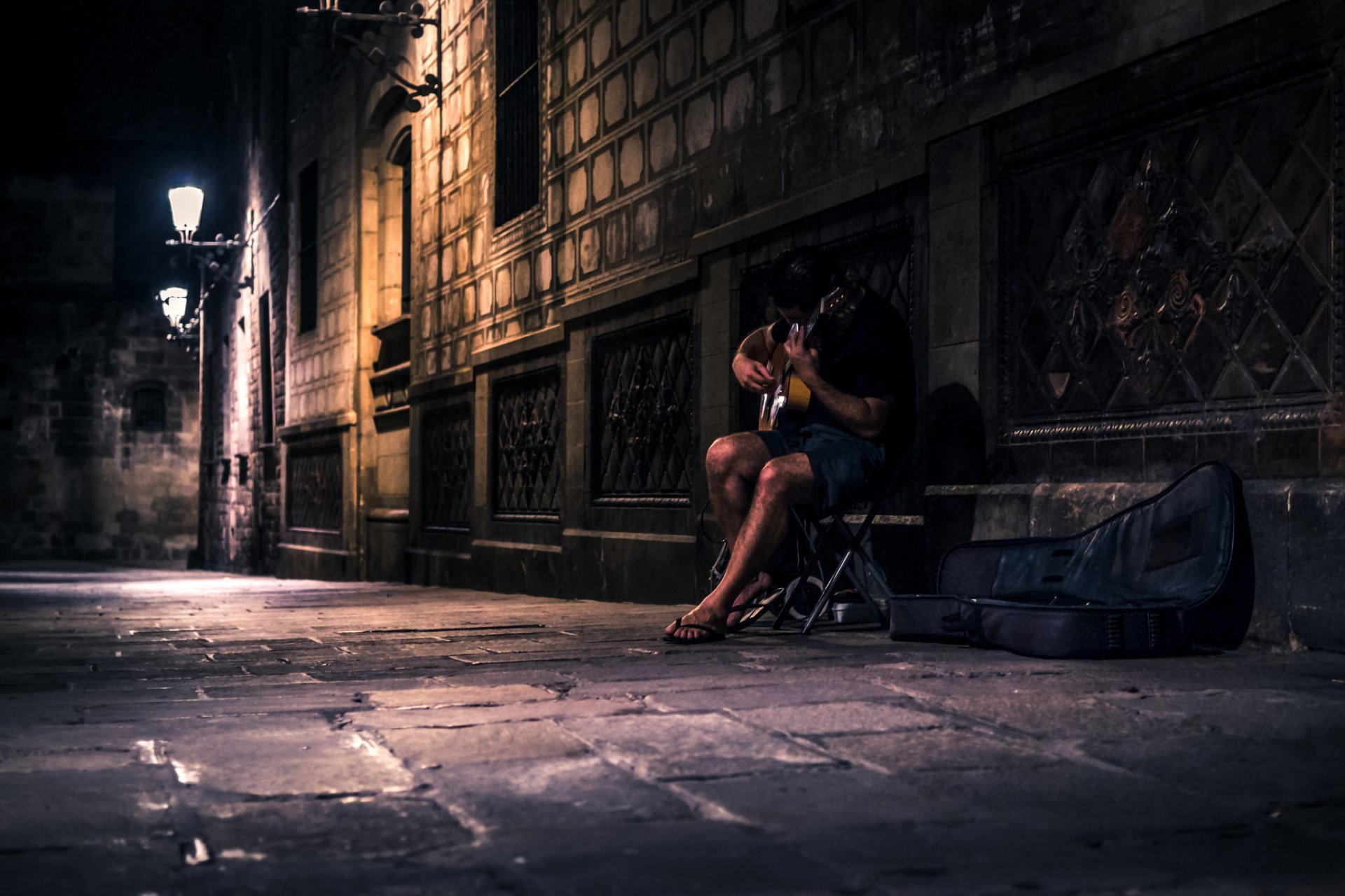 man guitars street night music