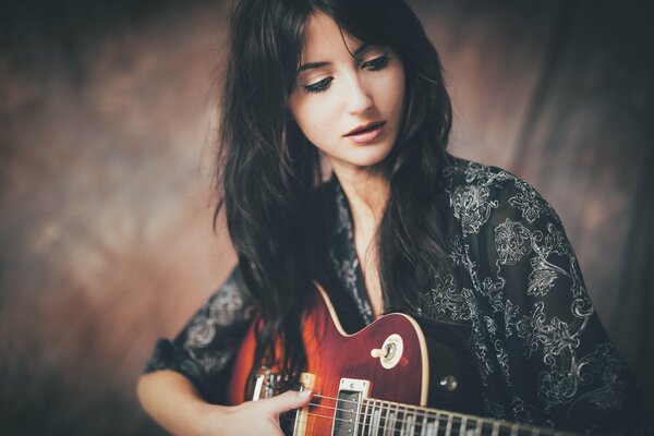 Beautiful girl playing guitar