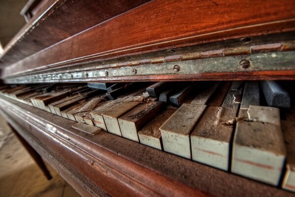 Macro photo of an old broken piano with broken keys