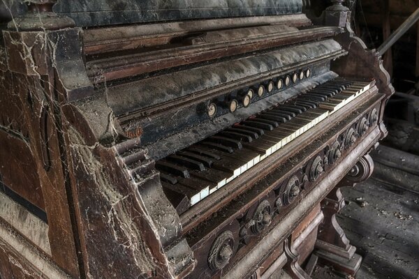 Eine alte Orgel, die mit Staub und Spinnweben bedeckt ist