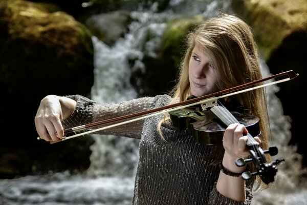 A girl with long hair plays the violin