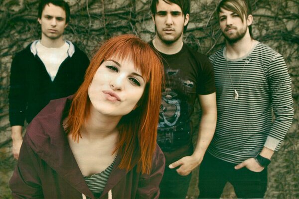 Rock band of four with a red-haired girl