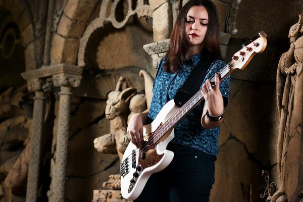 A girl plays guitar in a beautiful place