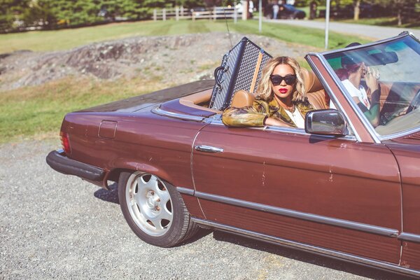 The famous singer in a brown convertible