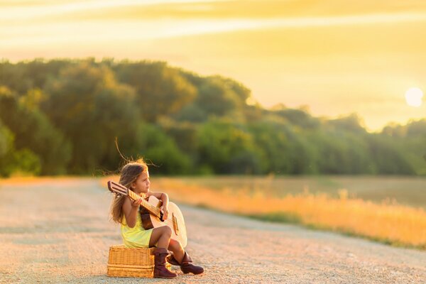 Girl playing guitar on the road