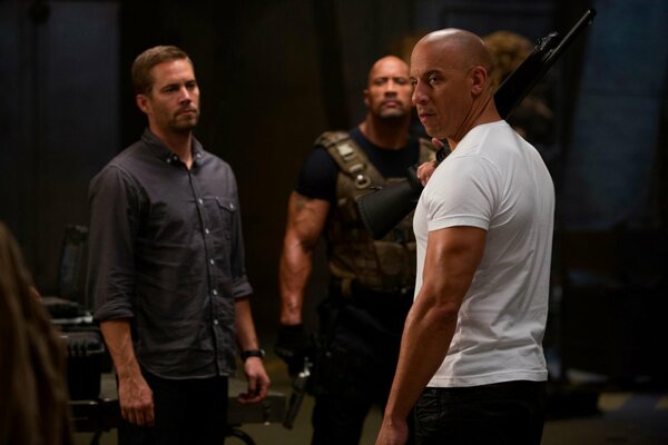 Three men with guns, a shot from the movie fast and furious
